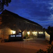 Verlichte buitengevel van Hotel Oude Eycke in de avond