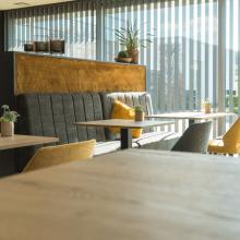 Tafels en zitbank in het interieur van OKER